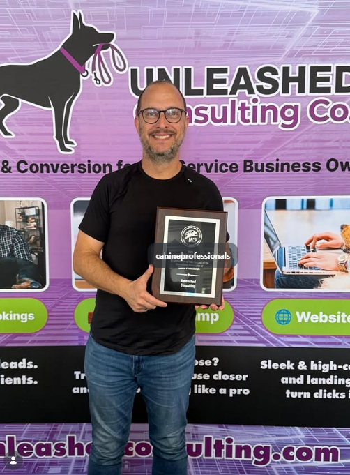 Unleashed Consulting receiving a Titanium Sponsor recognition plaque from the International Association of Canine Professionals.